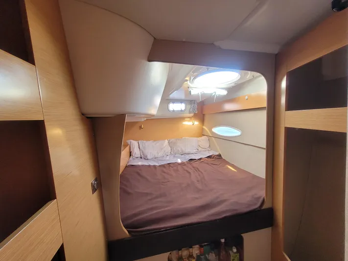 Knotty Nature Yacht Photos Pics Cozy bedroom in 2011 Fountaine Pajot Lipari 41 catamaran with natural light and wood accents.