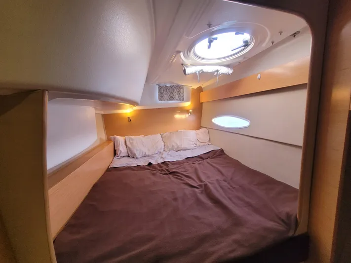 Knotty Nature Yacht Photos Pics Cozy cabin interior of 2011 Fountaine Pajot Lipari 41 catamaran with bed and porthole.