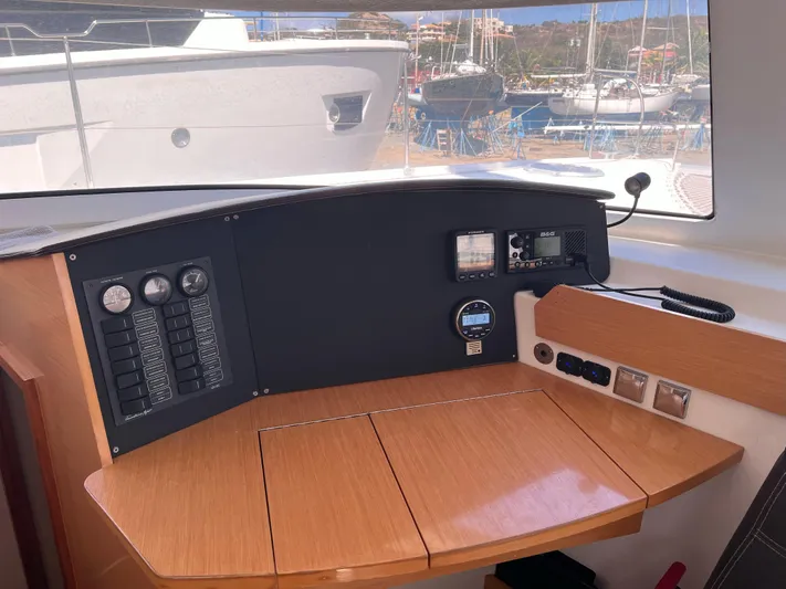 Knotty Nature Yacht Photos Pics Interior helm station of 2011 Fountaine Pajot Lipari 41 catamaran with control panel.