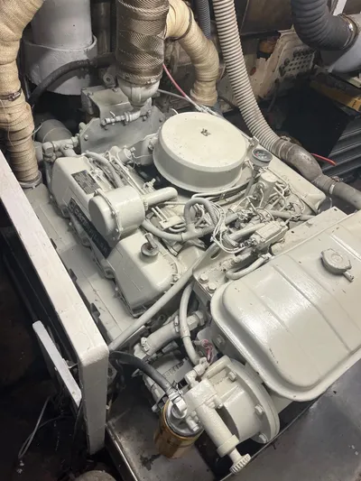 Dauntless Yacht Photos Pics Custom 1990 engine with hoses and components in a mechanical setting.