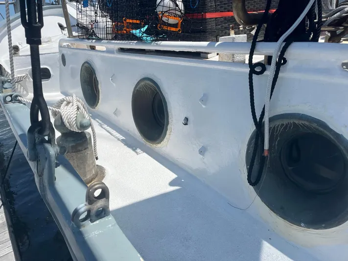 Dauntless Yacht Photos Pics Custom 1990 boat deck with ropes, portholes, and equipment in sunlight.