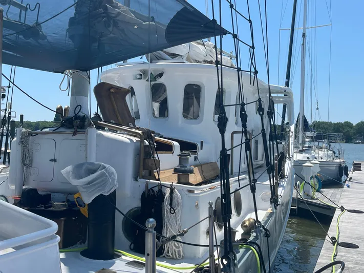 Dauntless Yacht Photos Pics A custom 1990 sailboat docked at a marina under a clear blue sky.