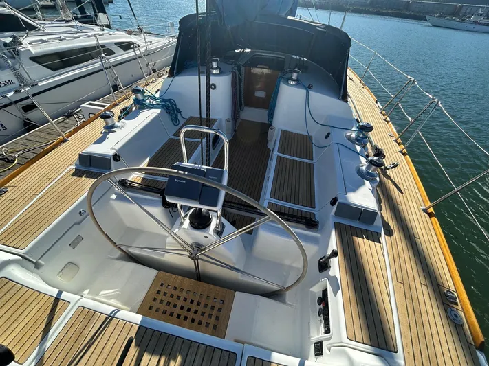 Veronese Yacht Photos Pics 2003 Beneteau First 47.7 sailboat cockpit with wooden deck and steering wheel.