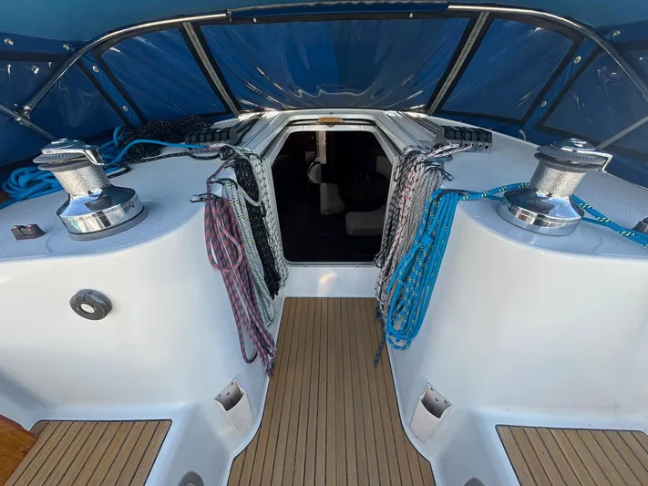 Veronese Yacht Photos Pics 2003 Beneteau First 47.7 yacht cockpit with winches and ropes under blue canopy.