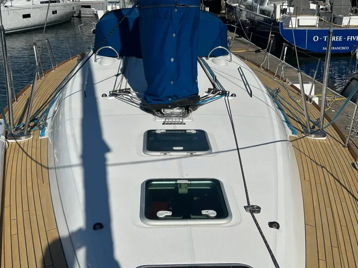 Veronese Yacht Photos Pics 2003 Beneteau First 47.7 sailboat deck with blue cover, docked at marina.