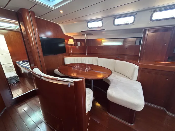 Veronese Yacht Photos Pics Luxurious interior of 2003 Beneteau First 47.7 yacht with elegant wood finish and cozy seating.