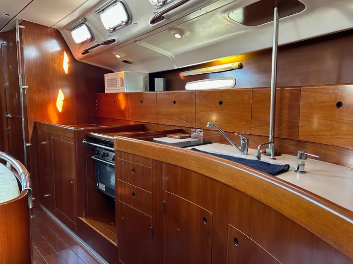 Veronese Yacht Photos Pics Interior of 2003 Beneteau First 47.7 yacht, featuring a sleek wooden kitchen design.