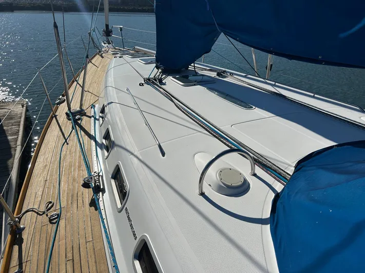 Veronese Yacht Photos Pics 2003 Beneteau First 47.7 sailboat deck with blue covers, docked by the water.