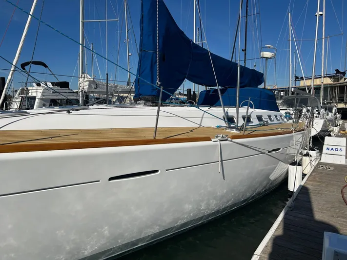 Veronese Yacht Photos Pics 2003 Beneteau First 47.7 sailboat docked, featuring sleek design and blue sail cover.