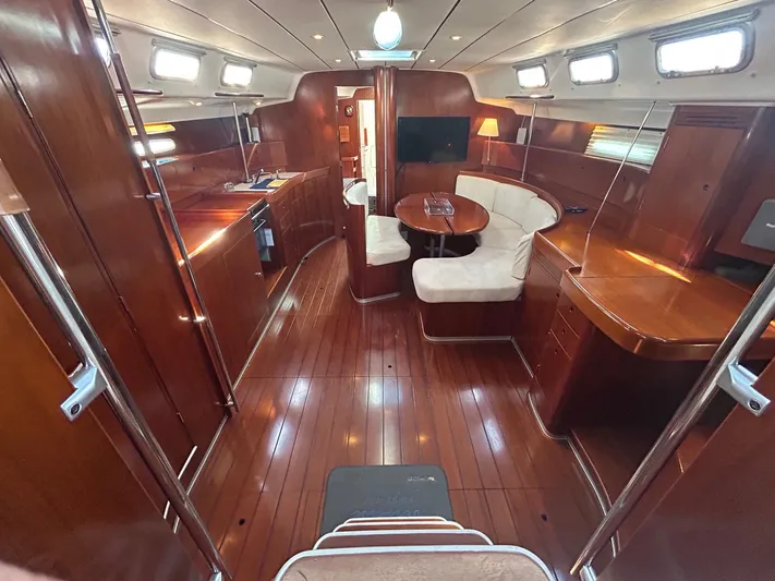 Veronese Yacht Photos Pics Luxurious interior of 2003 Beneteau First 47.7 yacht with polished wood and cozy seating.