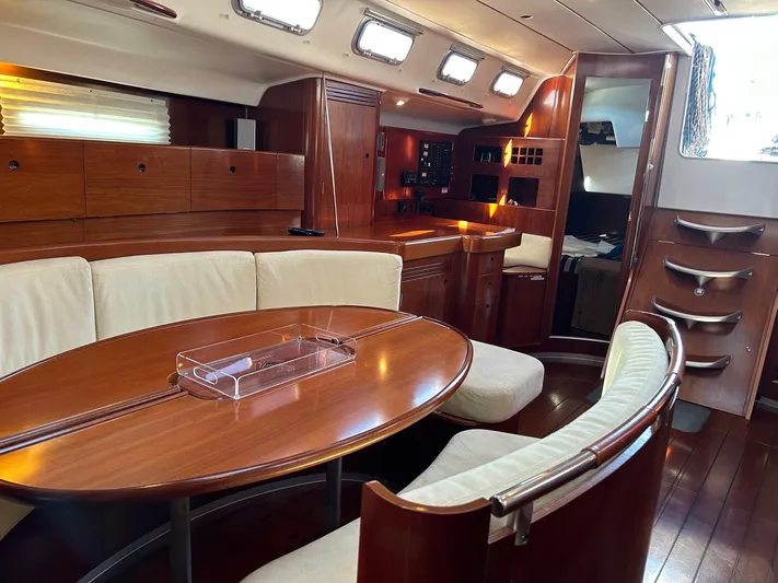 Veronese Yacht Photos Pics Luxurious interior of 2003 Beneteau First 47.7 yacht with elegant wood finish and seating area.