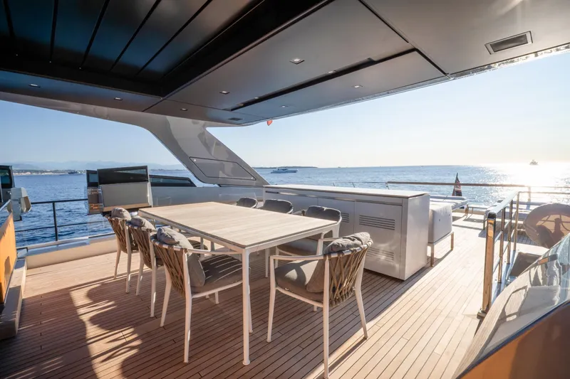 Le Gypsy Yacht Photos Pics Luxurious 2018 Sanlorenzo 102A yacht deck with dining area, overlooking serene ocean view.