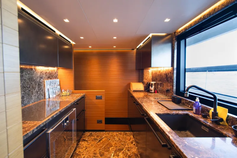 Le Gypsy Yacht Photos Pics Luxurious kitchen interior on 2018 Sanlorenzo 102A yacht with marble countertops and modern appliances.
