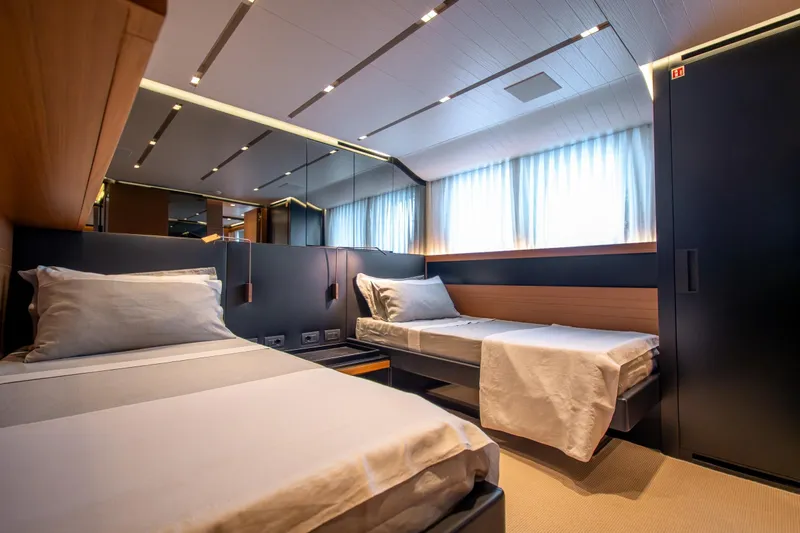Le Gypsy Yacht Photos Pics Luxurious twin bedroom on 2018 Sanlorenzo 102A yacht, featuring modern design and ambient lighting.