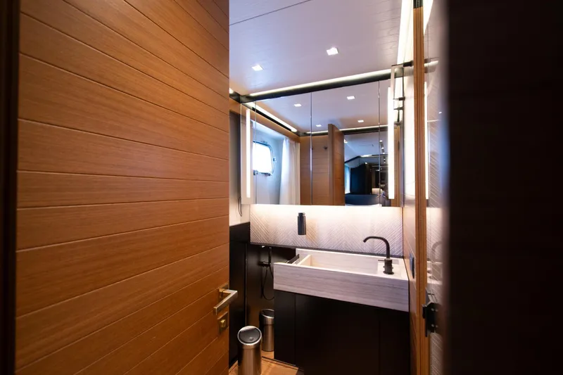Le Gypsy Yacht Photos Pics Luxurious bathroom interior on 2018 Sanlorenzo 102A yacht, featuring modern wood paneling and sleek fixtures.