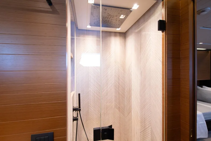 Le Gypsy Yacht Photos Pics Luxurious shower area in 2018 Sanlorenzo 102A yacht with modern wood paneling.