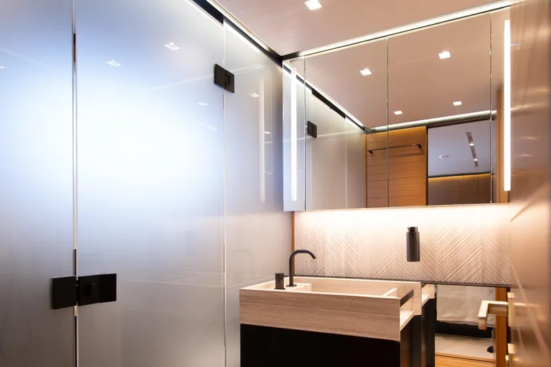 Le Gypsy Yacht Photos Pics Luxurious bathroom interior on 2018 Sanlorenzo 102A yacht, featuring modern sink and elegant lighting.