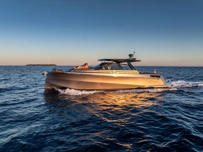 Virtus Yacht Photos Pics 2022 Steeler B50 AQUAZEN yacht cruising on open water at sunset.