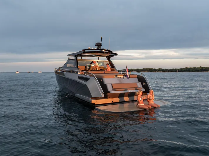 Virtus Yacht Photos Pics 2022 Steeler B50 AQUAZEN yacht on calm water with people relaxing at the stern.