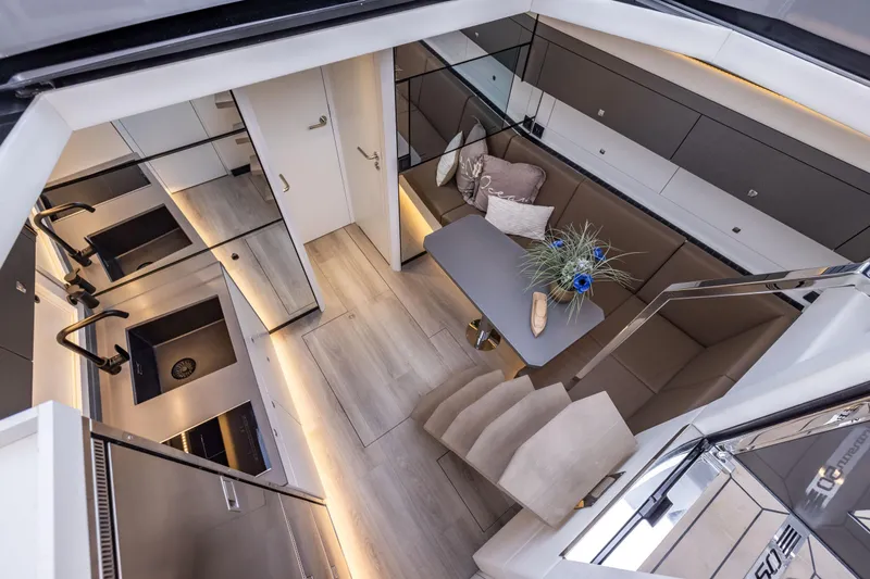 Virtus Yacht Photos Pics Luxurious interior of 2022 Steeler B50 AQUAZEN yacht with modern kitchen and seating area.
