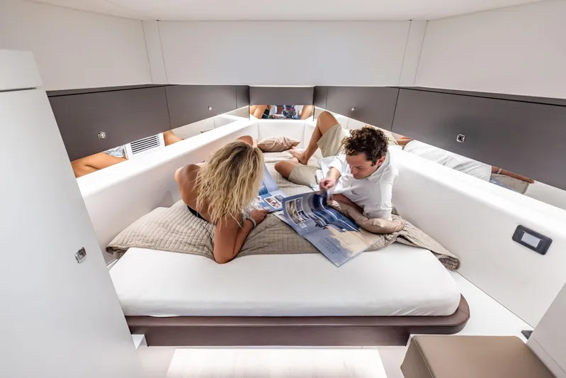 Virtus Yacht Photos Pics Couple relaxing in the luxurious cabin of a 2022 Steeler B50 AQUAZEN yacht.