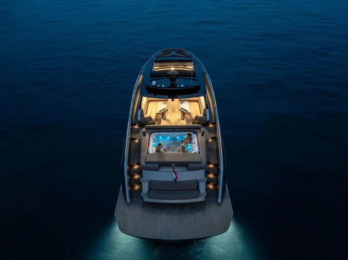 Virtus Yacht Photos Pics Luxurious 2022 Steeler B50 AQUAZEN yacht with illuminated deck and hot tub at night.