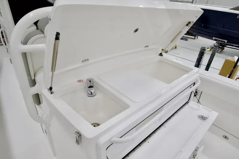 31-406 Yacht Photos Pics 2026 Regulator 31 boat with open storage compartment and faucet in a clean, white interior.