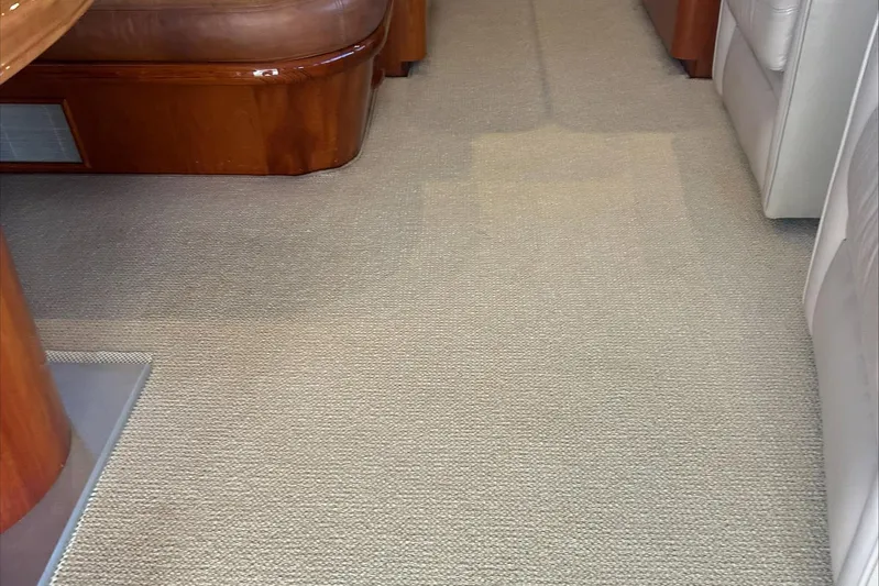 Lucky Yacht Photos Pics Interior of 1983 Rybovich 55 Convertible yacht with beige carpet and wooden furniture.