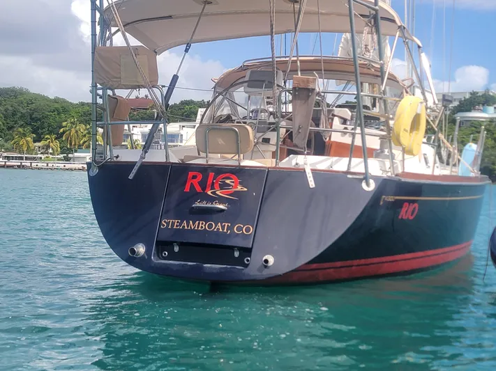 Rio Yacht Photos Pics Tartan 4300 sailboat named "RIO" docked in clear blue water, 2008 model.