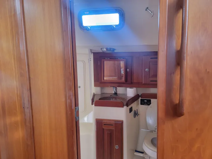 Rio Yacht Photos Pics 2008 Tartan 4300 yacht bathroom with wooden cabinetry and compact design.