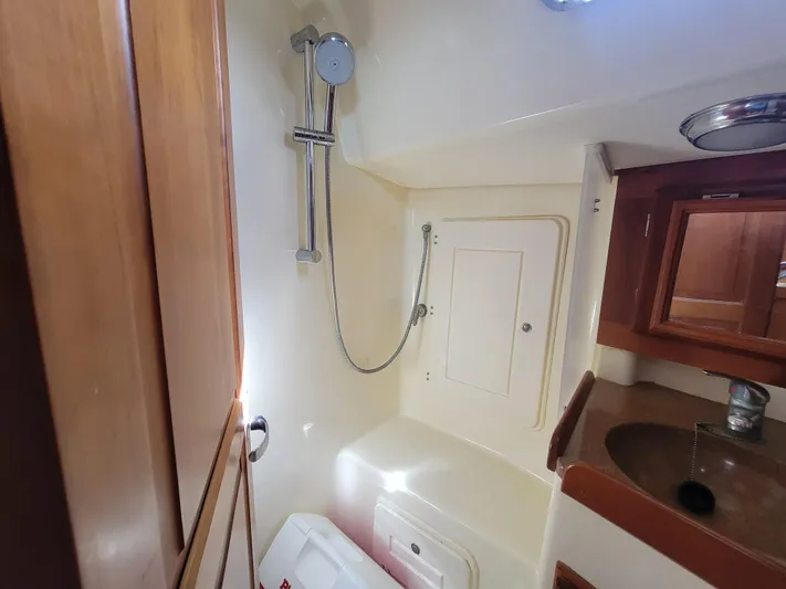 Rio Yacht Photos Pics Bathroom interior of 2008 Tartan 4300 yacht with shower and wooden cabinetry.