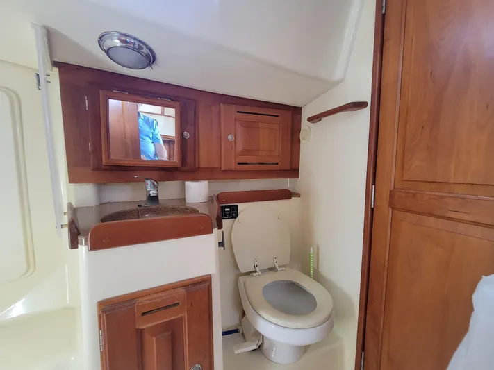 Rio Yacht Photos Pics 2008 Tartan 4300 yacht bathroom with wooden cabinets and modern fixtures.