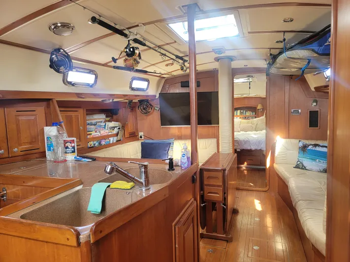 Rio Yacht Photos Pics Interior of 2008 Tartan 4300 sailboat with cozy seating, kitchen, and wooden finishes.
