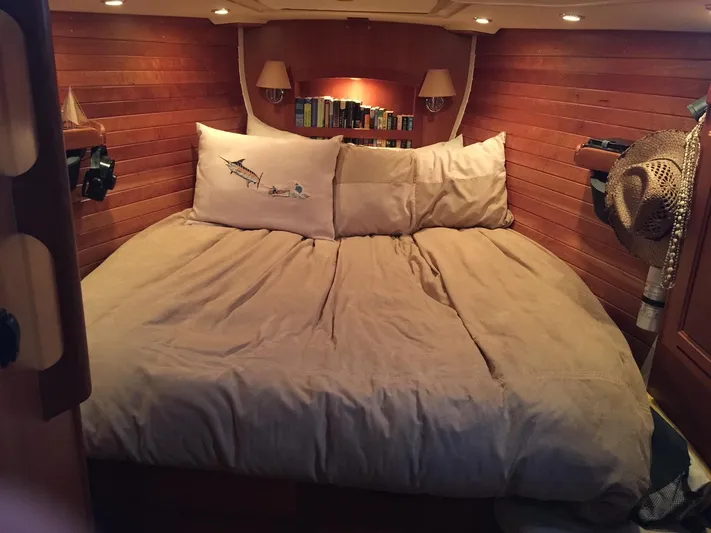 Rio Yacht Photos Pics Cozy cabin bedroom in 2008 Tartan 4300 yacht with wooden walls and soft lighting.