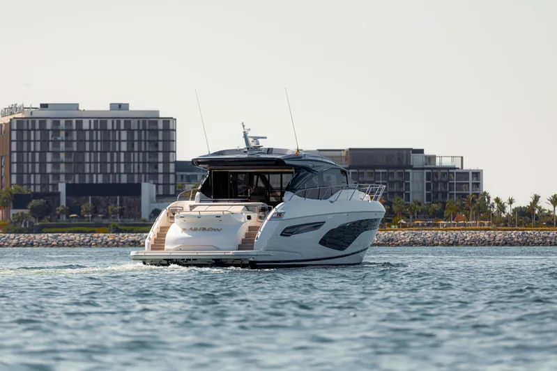  Yacht Photos Pics 2020 Princess V60 yacht cruising near modern waterfront buildings.