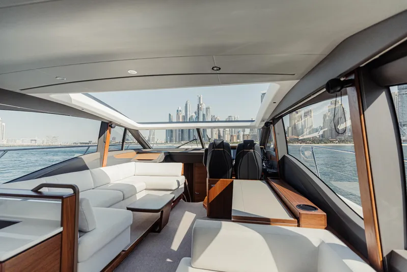  Yacht Photos Pics Luxurious 2020 Princess V60 yacht interior with city skyline view through large windows.