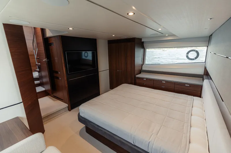  Yacht Photos Pics Luxurious bedroom interior of 2020 Princess V60 yacht with modern furnishings and sea view.