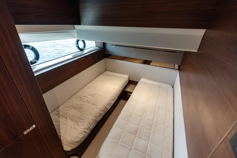 Yacht Photos Pics 2020 Princess V60 yacht cabin with twin beds and wooden interior.