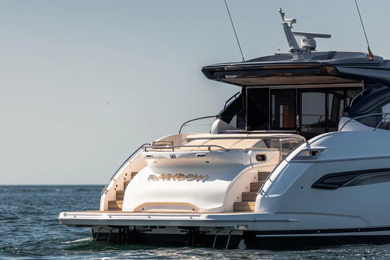  Yacht Photos Pics Luxury 2020 Princess V60 yacht on calm sea, rear view with open deck.