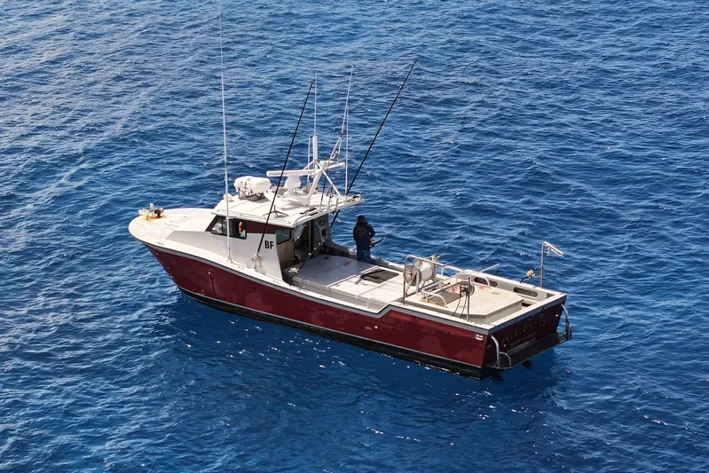  Yacht Photos Pics Custom Hoku 40 boat from 2018 on open blue sea, with fishing equipment.