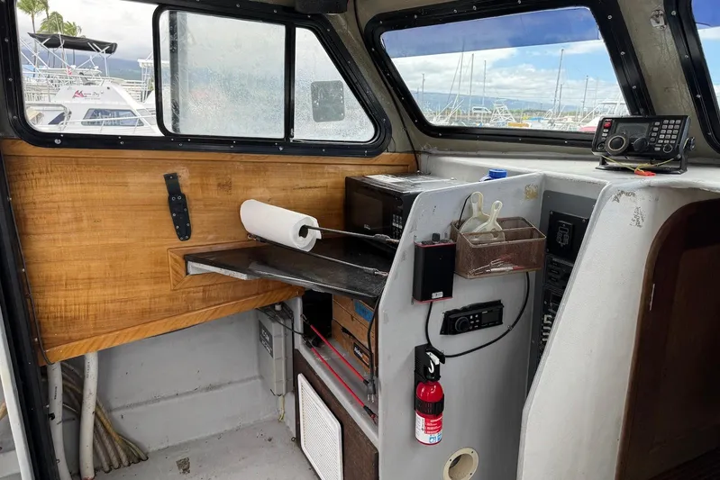  Yacht Photos Pics Interior of a 2018 Custom Hoku 40 boat with navigation equipment and storage.