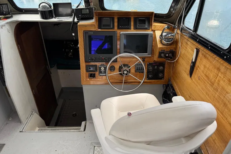  Yacht Photos Pics Interior of a 2018 Custom Hoku 40 boat with steering wheel and navigation equipment.