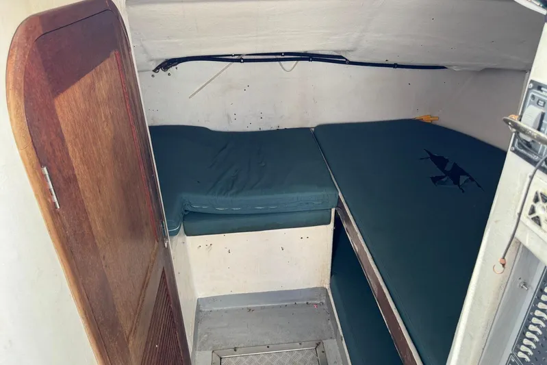  Yacht Photos Pics Small cabin interior of a 2018 Custom Hoku 40 boat with blue cushions.