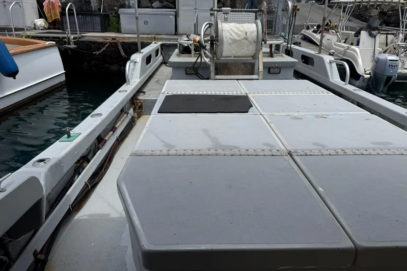  Yacht Photos Pics Custom Hoku 40 boat deck, 2018 model, docked at marina with fishing equipment.