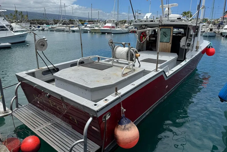  Yacht Photos Pics Custom Hoku 40 boat docked in marina, surrounded by other vessels, 2018 model.