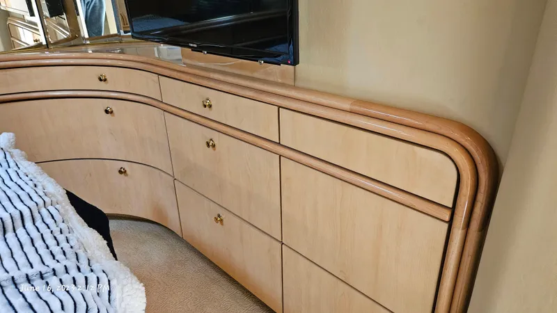 Dolce Vita Yacht Photos Pics Interior of 1999 Sea Ray 540 Sundancer with wooden cabinetry and mounted TV.