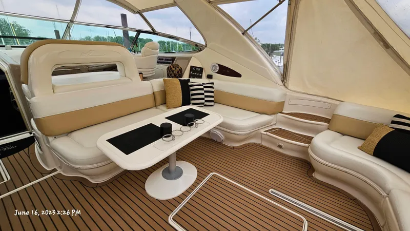 Dolce Vita Yacht Photos Pics Interior of 1999 Sea Ray 540 Sundancer yacht with seating area and table.