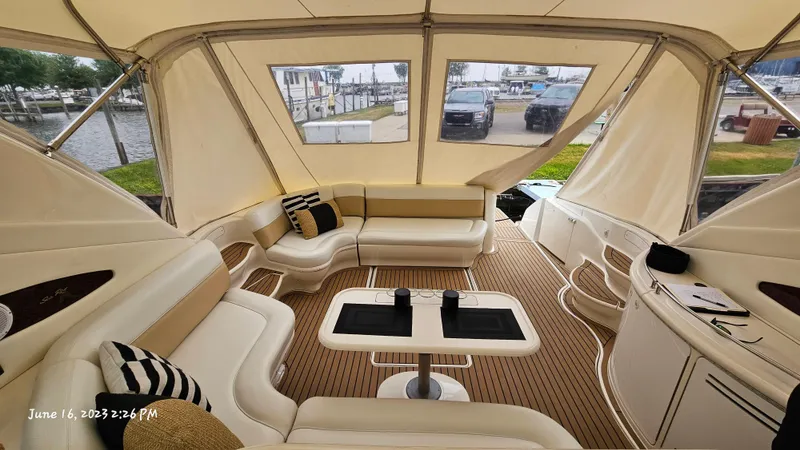 Dolce Vita Yacht Photos Pics Interior of 1999 Sea Ray 540 Sundancer yacht with beige seating and wooden flooring.