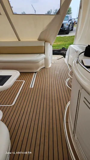Dolce Vita Yacht Photos Pics Interior of 1999 Sea Ray 540 Sundancer yacht with teak flooring and white seating.