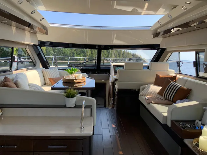  Yacht Photos Pics Luxurious interior of 2018 Carver C52 Coupe yacht with elegant seating and panoramic windows.